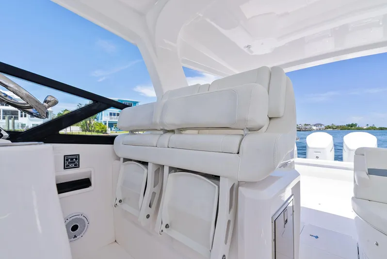 Tide Chaser Yacht Photos Pics 2022 Intrepid 438 Evolution boat interior with white seating and ocean view.