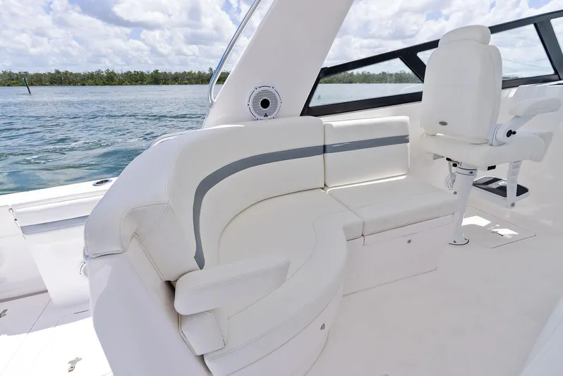 Tide Chaser Yacht Photos Pics Luxurious seating on 2022 Intrepid 438 Evolution yacht, featuring sleek white design and ocean view.