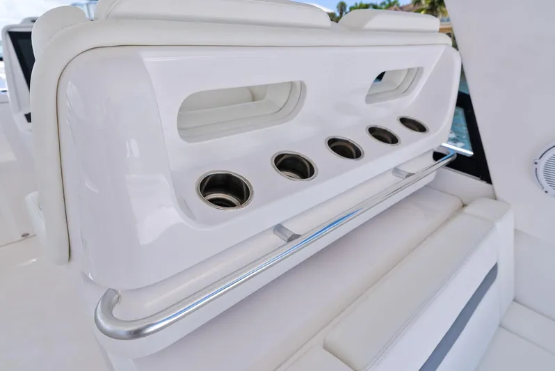 Tide Chaser Yacht Photos Pics 2022 Intrepid 438 Evolution boat interior with cup holders and sleek white seating.