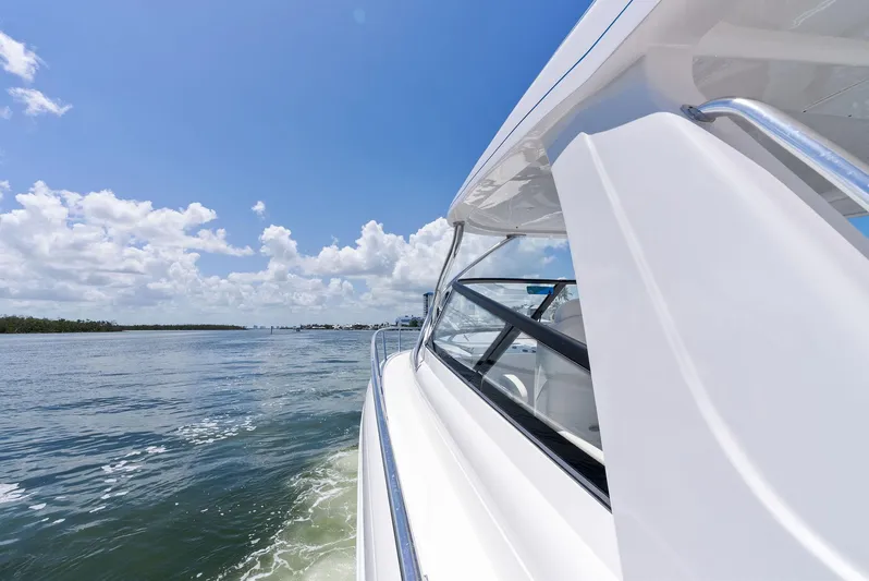 Tide Chaser Yacht Photos Pics 2022 Intrepid 438 Evolution yacht cruising on a sunny day with clear skies.