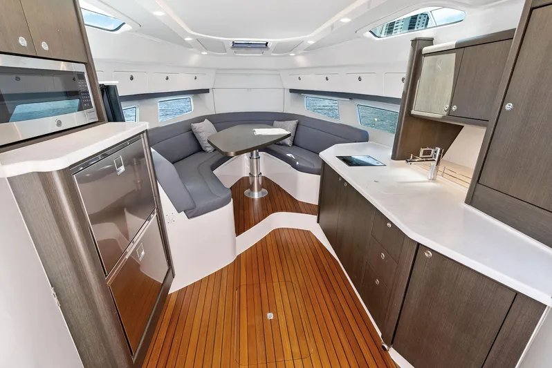 Tide Chaser Yacht Photos Pics Luxurious interior of 2022 Intrepid 438 Evolution yacht with modern kitchen and seating area.