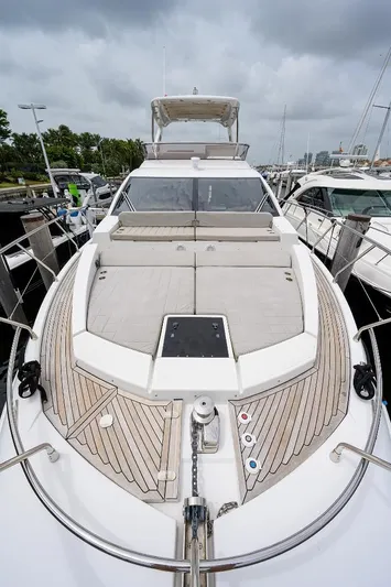 Vivere Yacht Photos Pics 2016 Azimut 50 yacht with sleek deck design, docked at marina under cloudy sky.