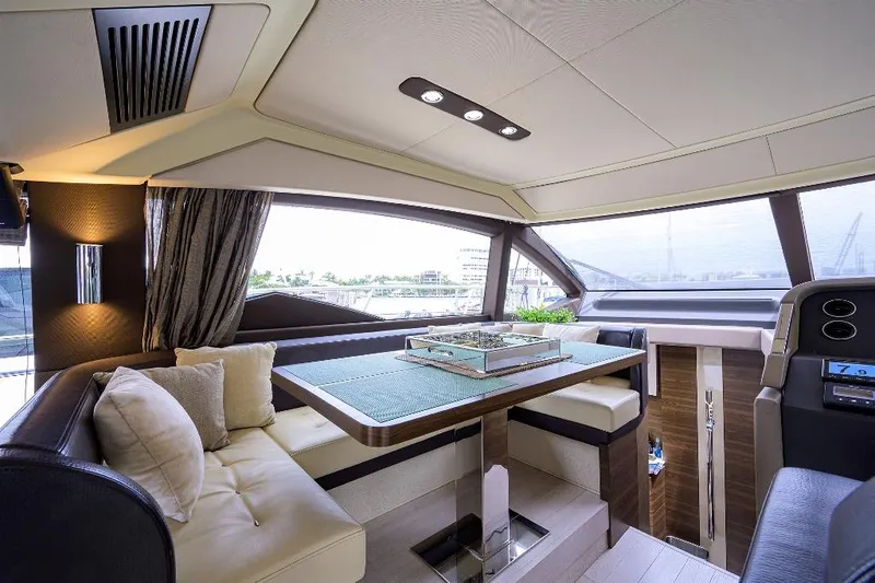 Vivere Yacht Photos Pics Luxurious interior of a 2016 Azimut 50 yacht with elegant seating and panoramic windows.