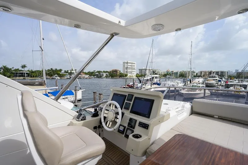 Vivere Yacht Photos Pics Luxurious 2016 Azimut 50 yacht interior with modern helm, docked in a scenic marina.