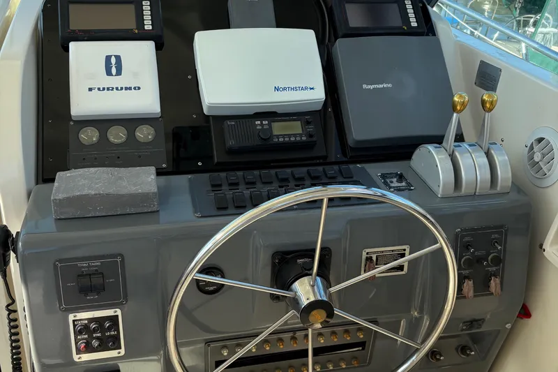 Mokai Yacht Photos Pics 1996 Tiara 4300 Open helm with navigation equipment and steering wheel.