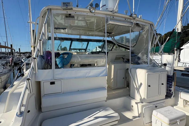 Mokai Yacht Photos Pics 1996 Tiara 4300 Open yacht with spacious cockpit and clear enclosure at marina.