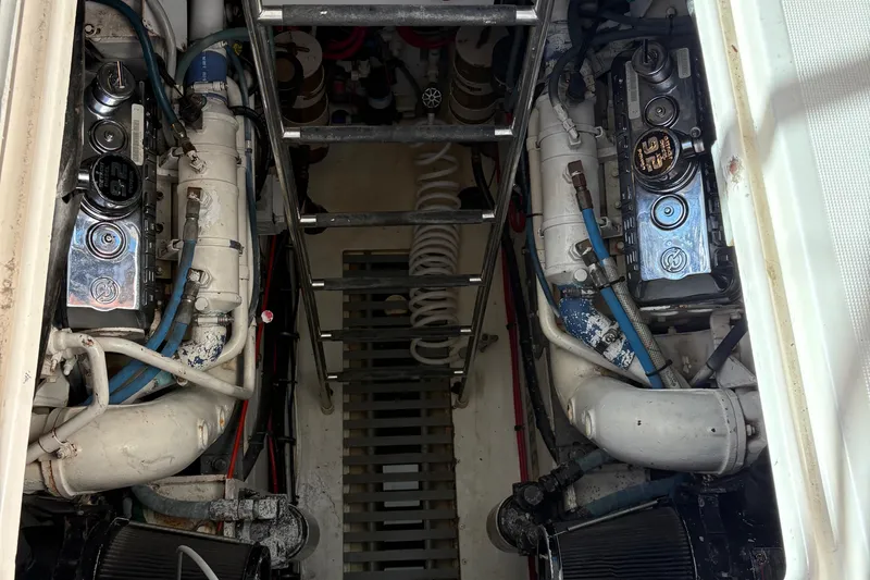 Mokai Yacht Photos Pics Engine room of a 1996 Tiara 4300 Open boat, showcasing dual engines and mechanical components.