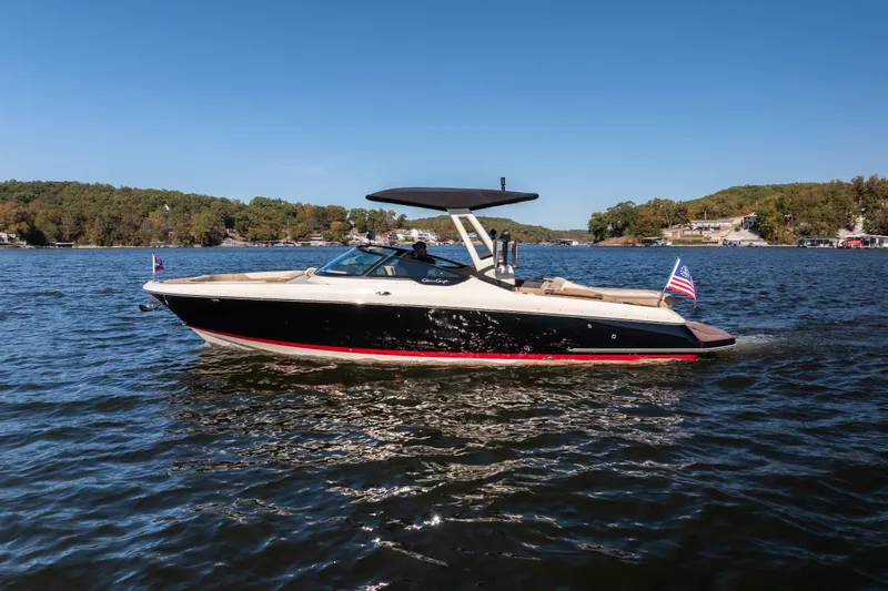  Yacht Photos Pics 2026 Chris-Craft Sportster 28 boat cruising on a scenic lake under clear blue skies.