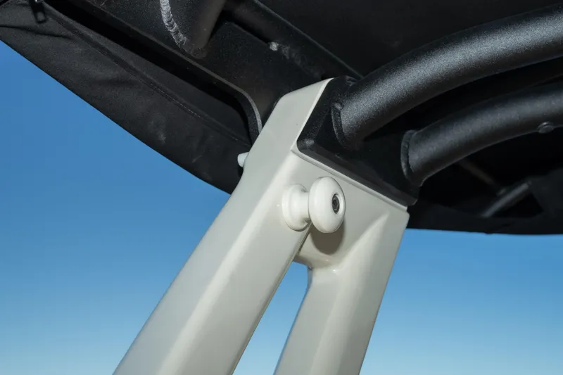  Yacht Photos Pics Close-up of 2026 Chris-Craft Sportster 28 boat canopy support against blue sky.