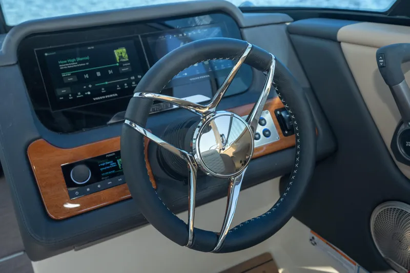  Yacht Photos Pics Steering wheel and dashboard of 2026 Chris-Craft Sportster 28 boat, featuring modern controls.