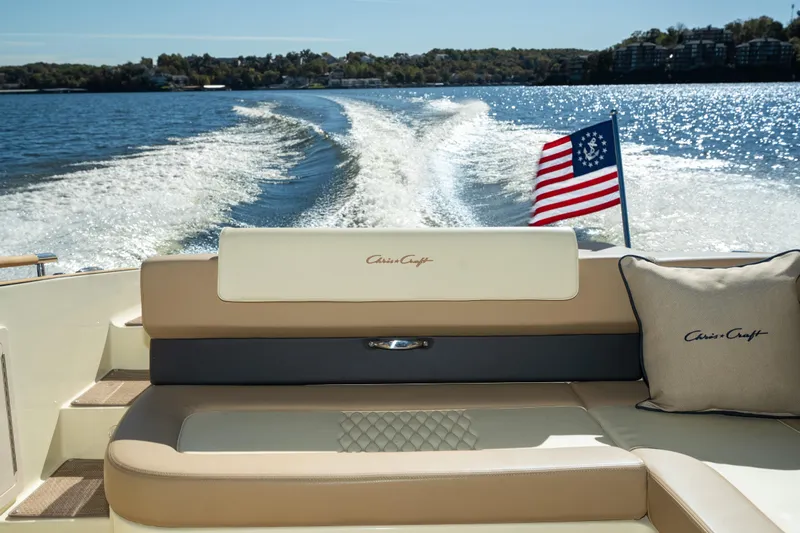  Yacht Photos Pics 2026 Chris-Craft Sportster 28 boat interior with American flag on a sunny lake.