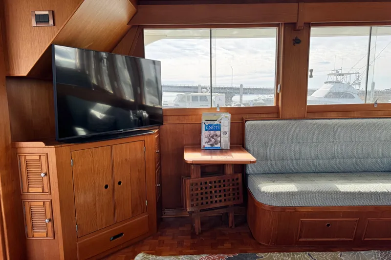Driftwood Yacht Photos Pics Interior of 2000 Grand Banks 52 Europa yacht with TV, sofa, and window view.