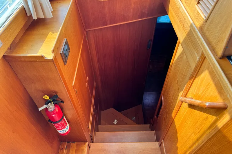 Driftwood Yacht Photos Pics Wooden staircase inside 2000 Grand Banks 52 Europa yacht with fire extinguisher.