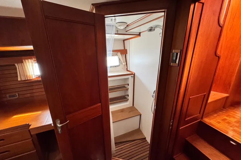 Driftwood Yacht Photos Pics Interior of 2000 Grand Banks 52 Europa yacht, featuring wooden cabinetry and compact shower area.