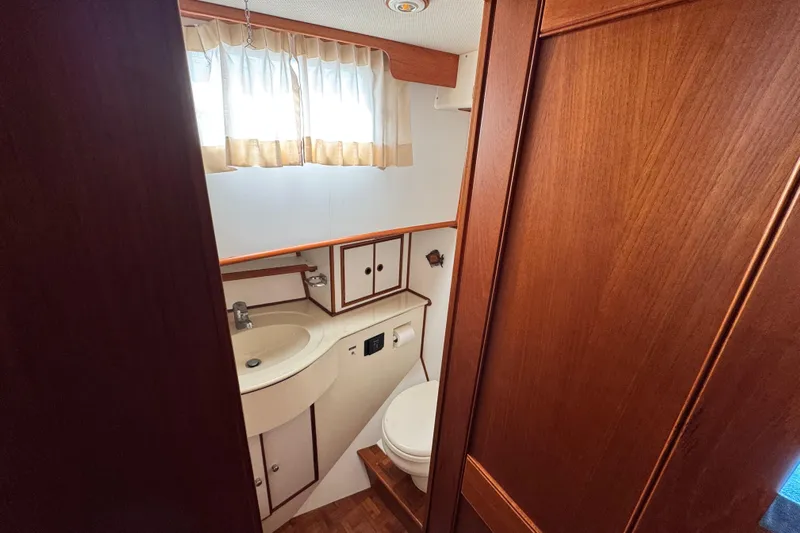 Driftwood Yacht Photos Pics Bathroom interior of 2000 Grand Banks 52 Europa yacht with wood paneling and compact design.