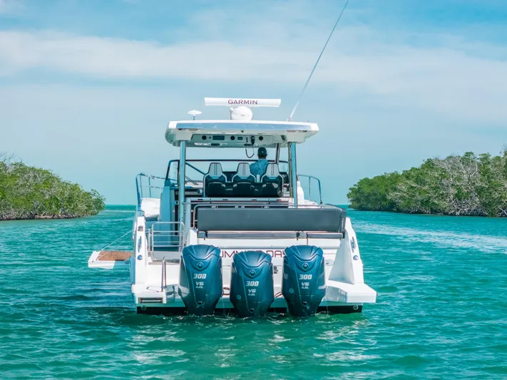  Yacht Photos Pics 2021 Jeanneau Leader 12.5 WA boat with triple 300 HP engines on turquoise water.