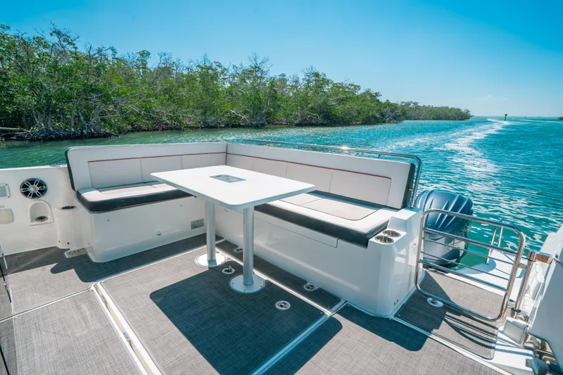  Yacht Photos Pics 2021 Jeanneau Leader 12.5 WA boat with spacious seating and table on deck.