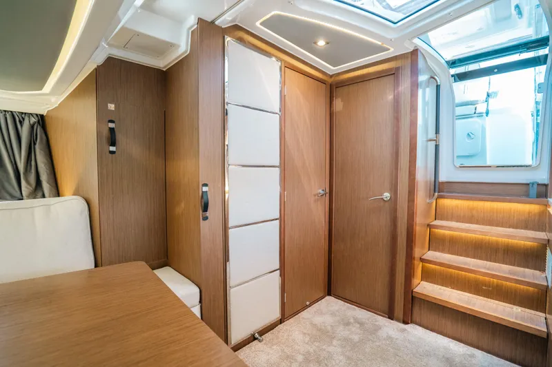  Yacht Photos Pics Interior of 2021 Jeanneau Leader 12.5 WA, featuring modern wood finishes and elegant lighting.