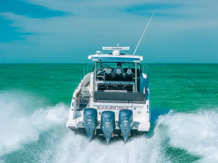  Yacht Photos Pics 2021 Jeanneau Leader 12.5 WA cruising on turquoise waters, rear view.