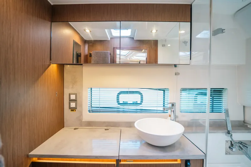  Yacht Photos Pics Modern bathroom interior of 2021 Jeanneau Leader 12.5 WA yacht with sleek design.