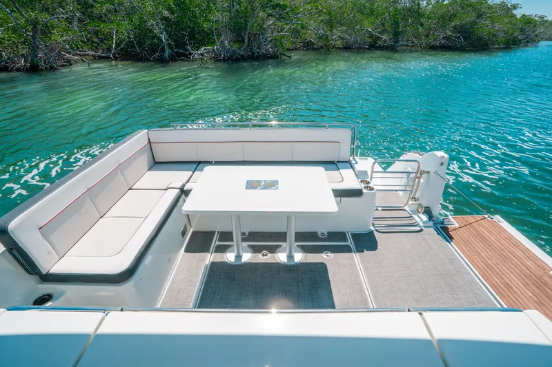  Yacht Photos Pics 2021 Jeanneau Leader 12.5 WA boat with spacious seating and table on turquoise water.