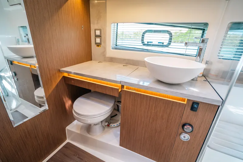  Yacht Photos Pics Modern bathroom interior of 2021 Jeanneau Leader 12.5 WA yacht with sleek design.