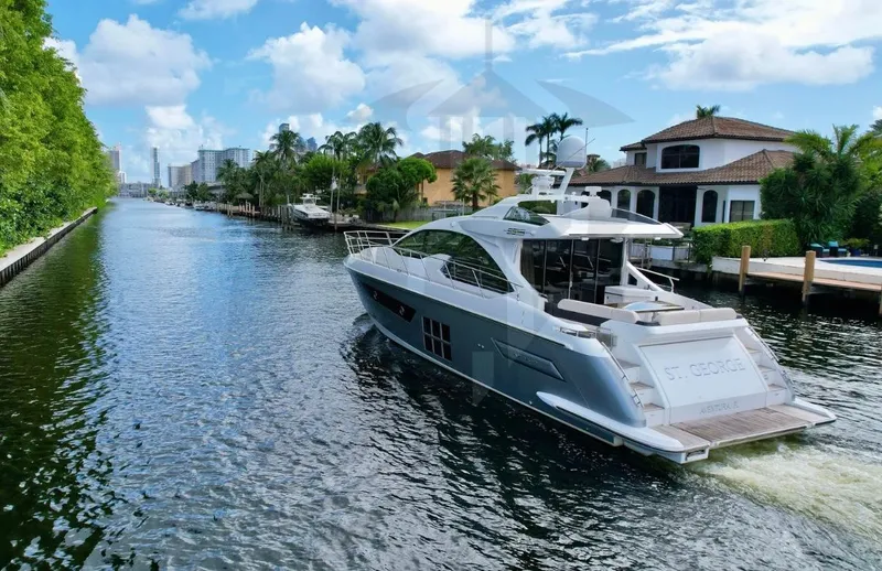 Saint George Yacht Photos Pics Azimut 55S 2015 yacht cruising on a scenic canal with luxury homes.