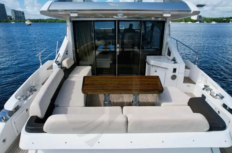 Saint George Yacht Photos Pics 2015 Azimut 55S yacht with spacious outdoor seating and table on calm water.