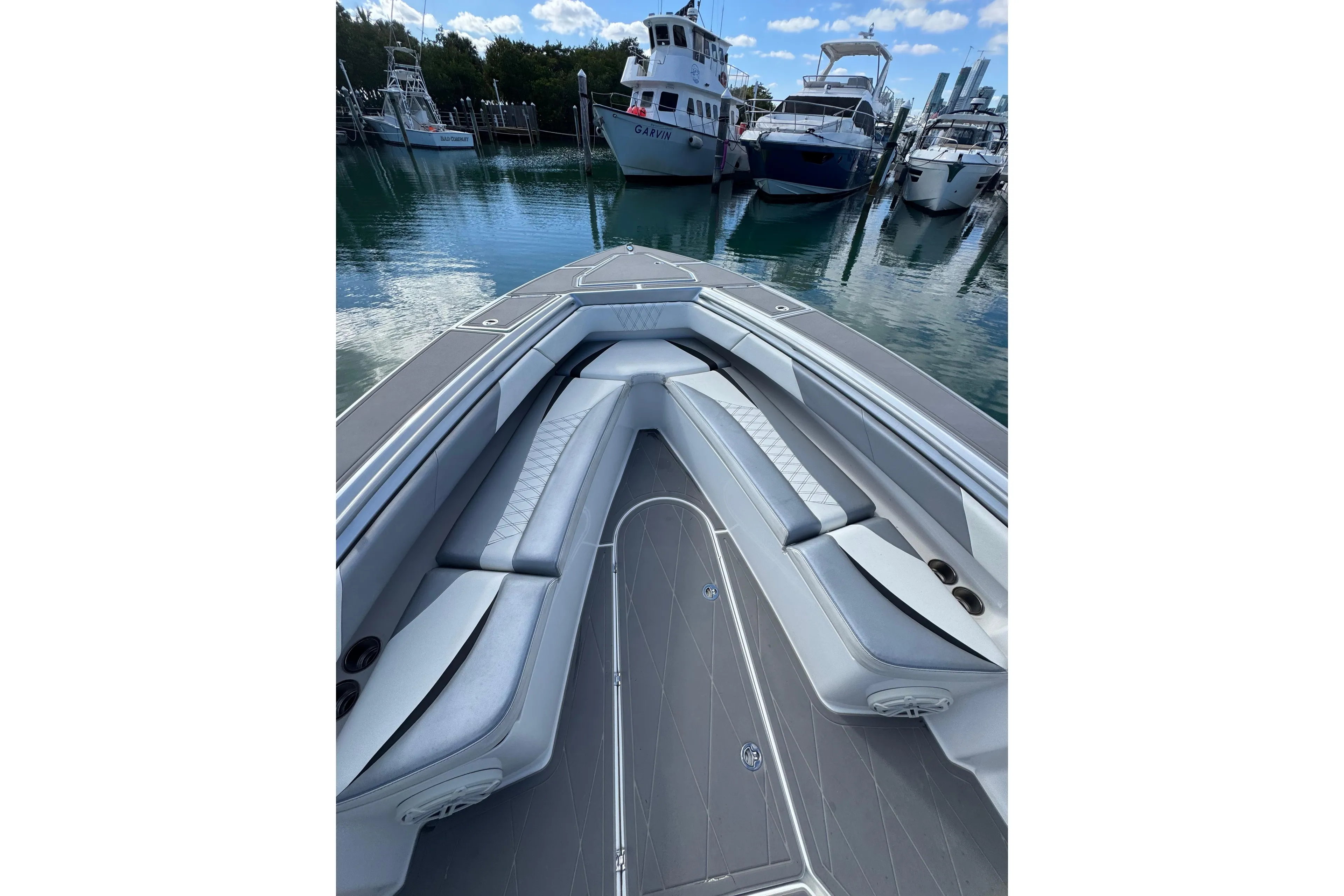 2019 Statement 380 Open boat interior with sleek seating at marina.