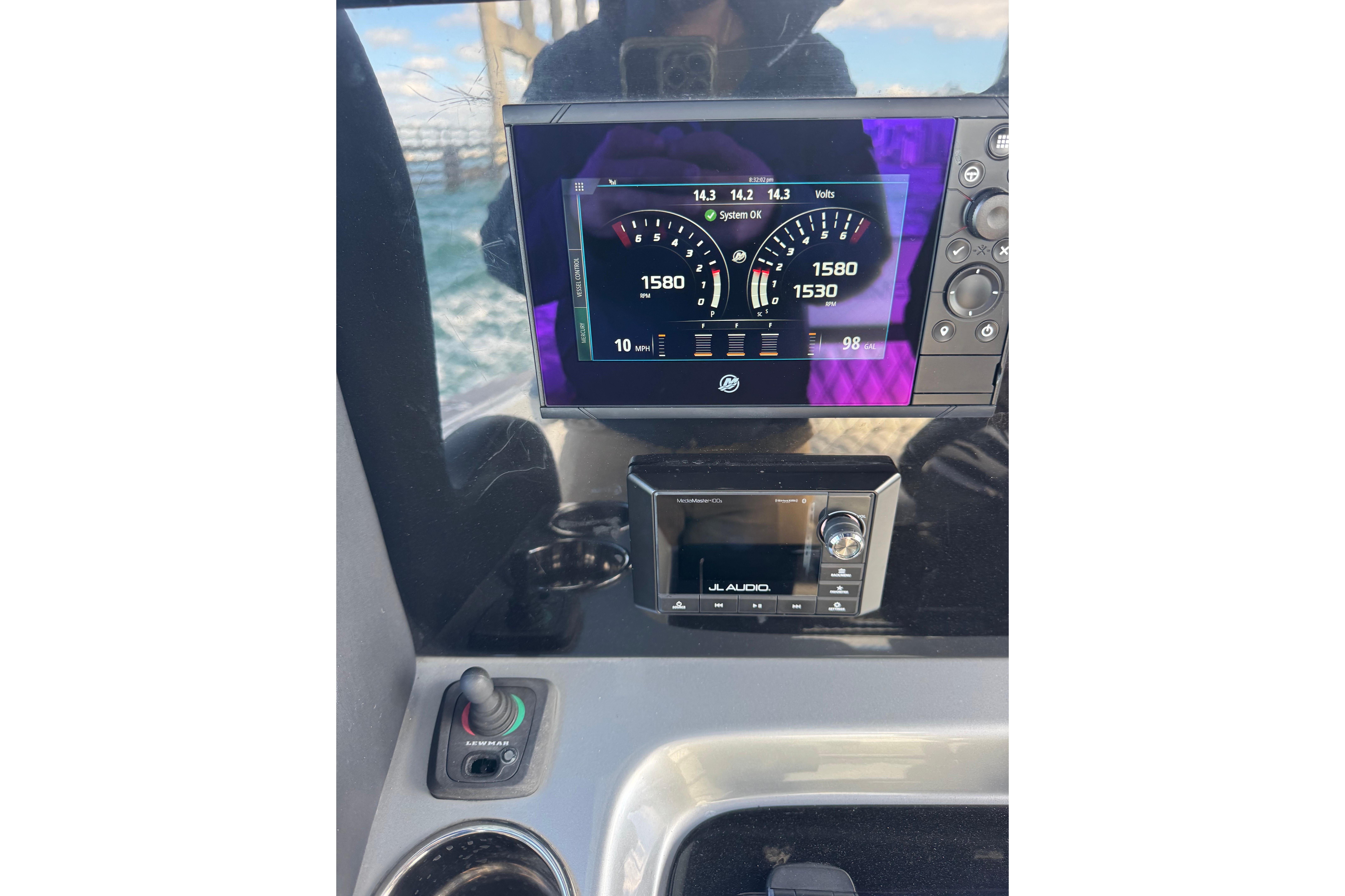 Dashboard of 2019 Statement 380 Open boat with digital gauges and audio system.