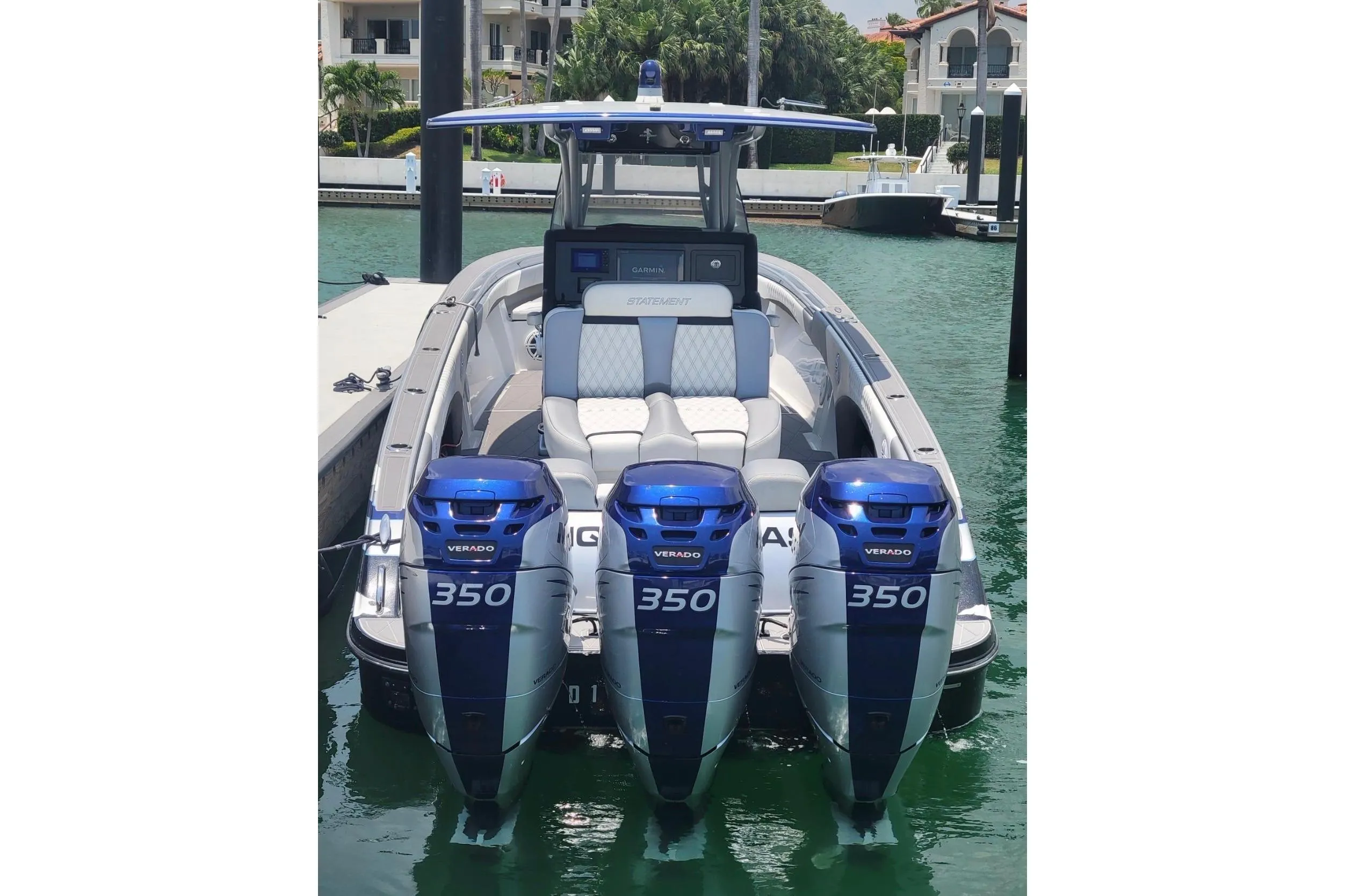 2019 Statement 380 Open boat with triple Mercury Verado 350 engines docked in marina.