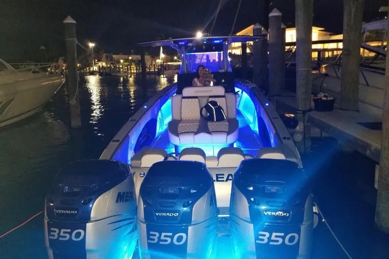  Yacht Photos Pics 2019 Statement 380 Open boat with blue LED lights docked at night.
