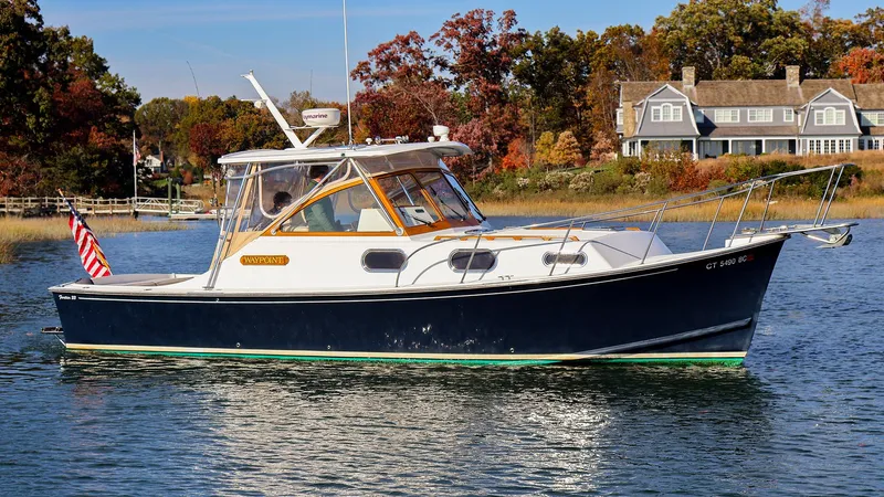 4804mm Yacht Photos Pics 2008 Fortier 33 boat on calm water with autumn foliage background.