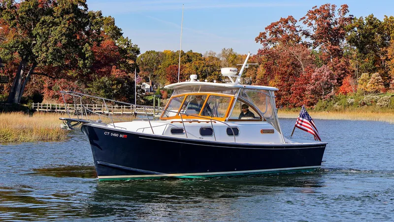 4804mm Yacht Photos Pics 2008 Fortier 33 boat cruising on a scenic lake with autumn foliage.