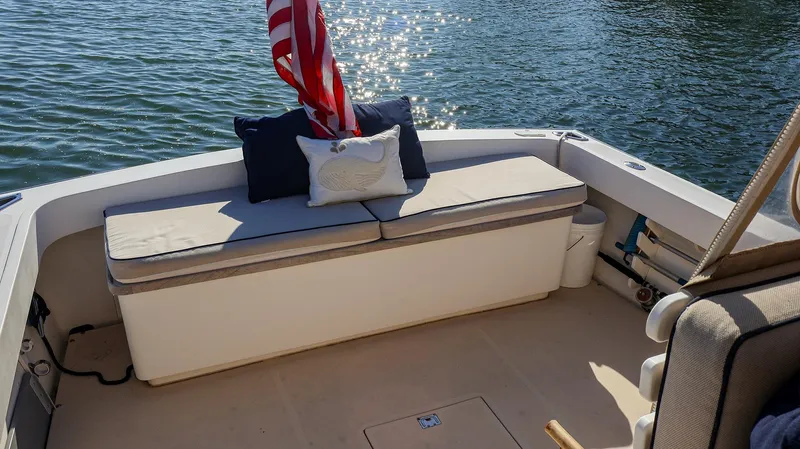 4804mm Yacht Photos Pics 2008 Fortier 33 boat with cushioned seating and American flag on calm water.