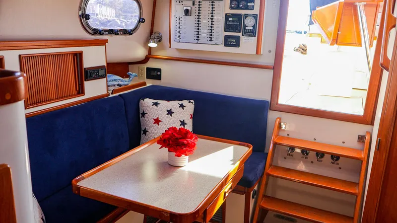 4804mm Yacht Photos Pics Interior of 2008 Fortier 33 boat with blue seating and table.