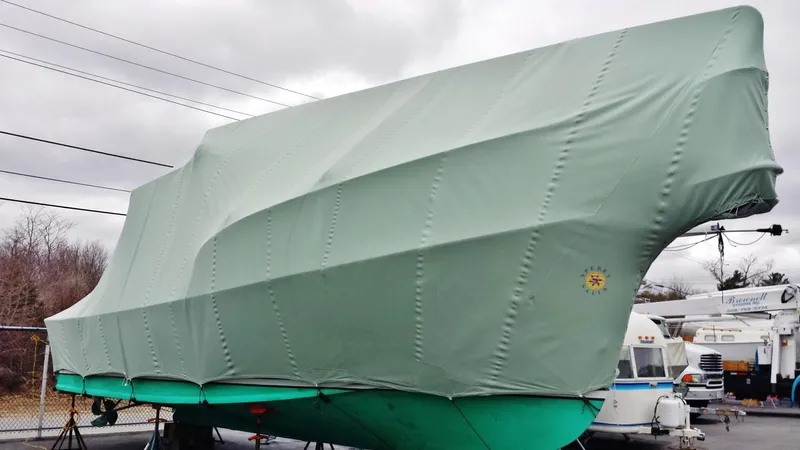 4804mm Yacht Photos Pics Fortier 33 boat, 2008 model, covered in green tarp, stored outdoors.