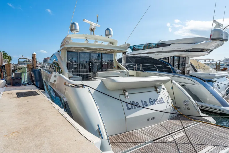 Life Is Great Yacht Photos Pics 2007 Azimut 62S luxury yacht docked at marina under clear blue sky.