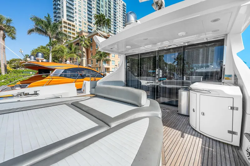 Life Is Great Yacht Photos Pics 2007 Azimut 62S yacht with spacious deck, modern design, and cityscape backdrop.