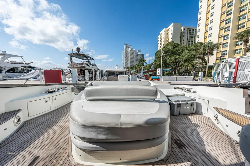 Life Is Great Yacht Photos Pics 2007 Azimut 62S yacht deck with seating, docked in a marina under a clear blue sky.