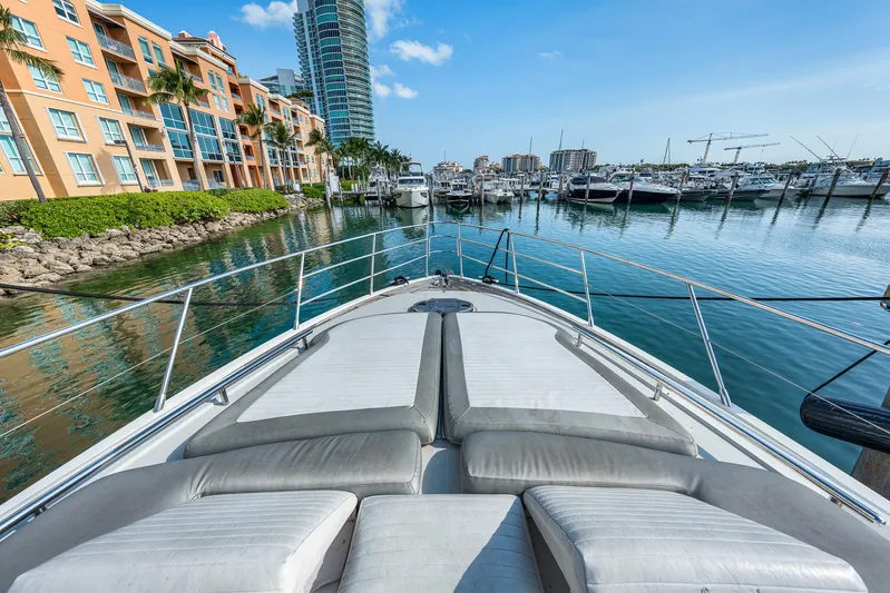 Life Is Great Yacht Photos Pics Azimut 62S yacht bow view in marina, 2007 model, with waterfront buildings and boats.