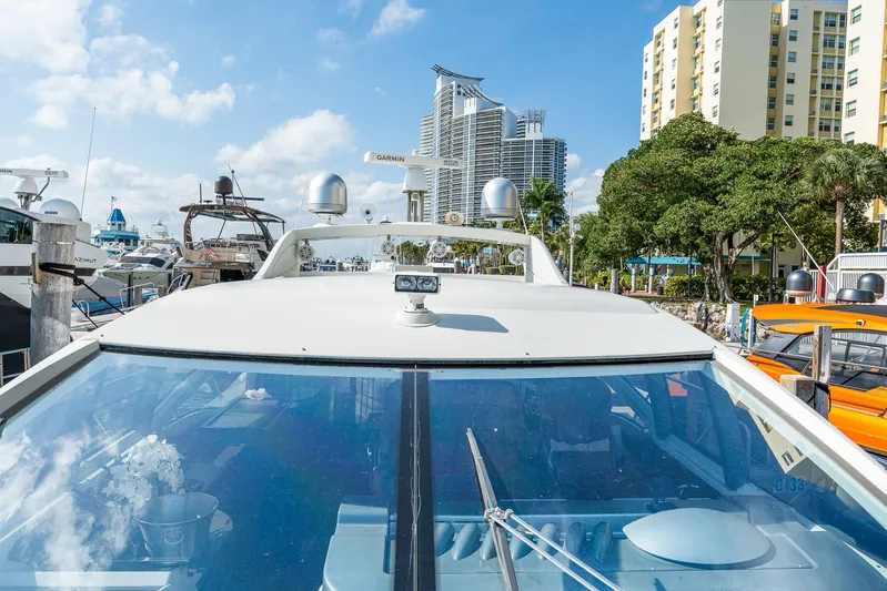 Life Is Great Yacht Photos Pics 2007 Azimut 62S yacht docked in a marina with cityscape background.