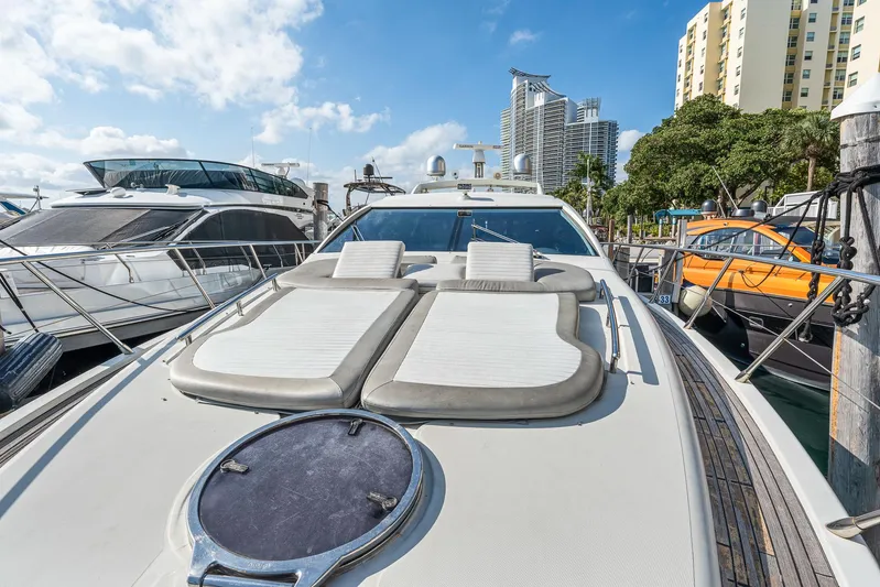 Life Is Great Yacht Photos Pics 2007 Azimut 62S yacht docked, featuring sun loungers and sleek design.