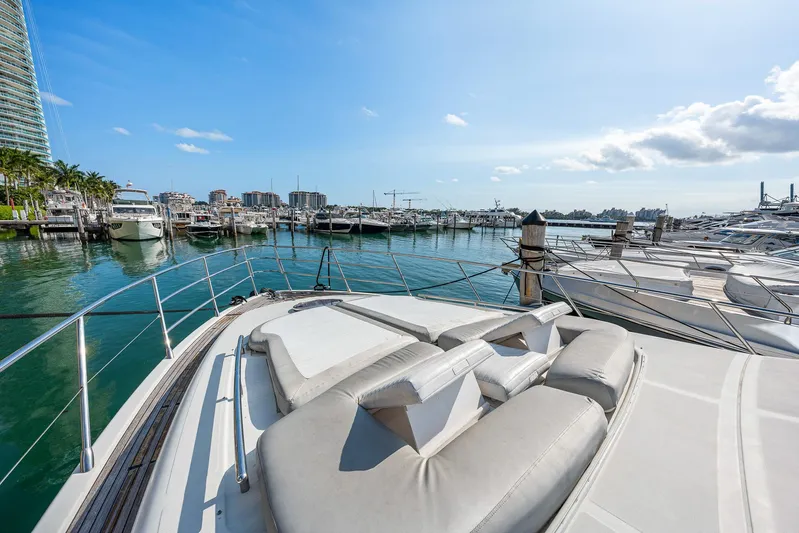 Life Is Great Yacht Photos Pics Luxurious 2007 Azimut 62S yacht docked in a sunny marina, featuring spacious sunbathing area.