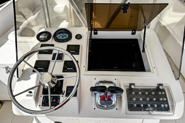  Yacht Photos Pics 1999 Intrepid 356 boat dashboard with steering wheel and control panel.