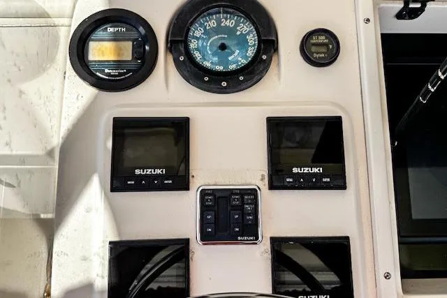  Yacht Photos Pics 1999 Intrepid 356 boat dashboard with Suzuki gauges and depth meter.