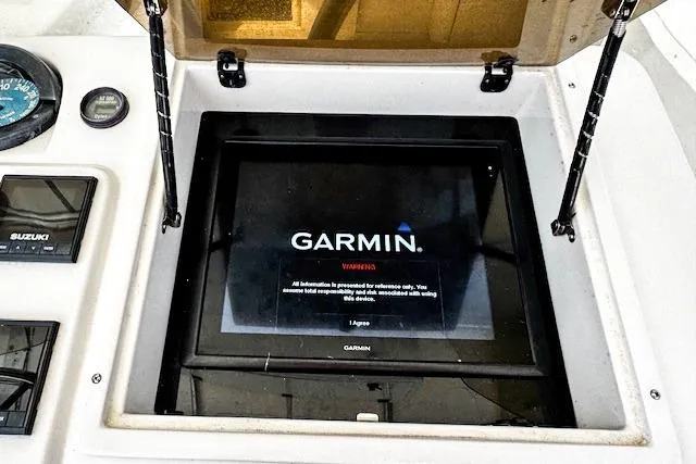  Yacht Photos Pics Garmin navigation system on 1999 Intrepid 356 boat dashboard, featuring Suzuki controls.