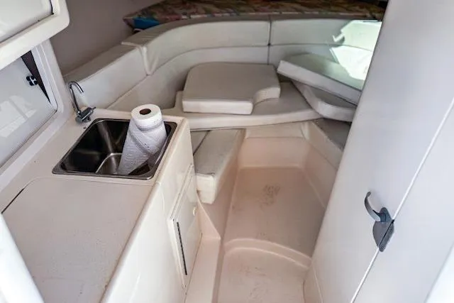  Yacht Photos Pics 1999 Intrepid 356 boat interior with sink, seating, and storage.