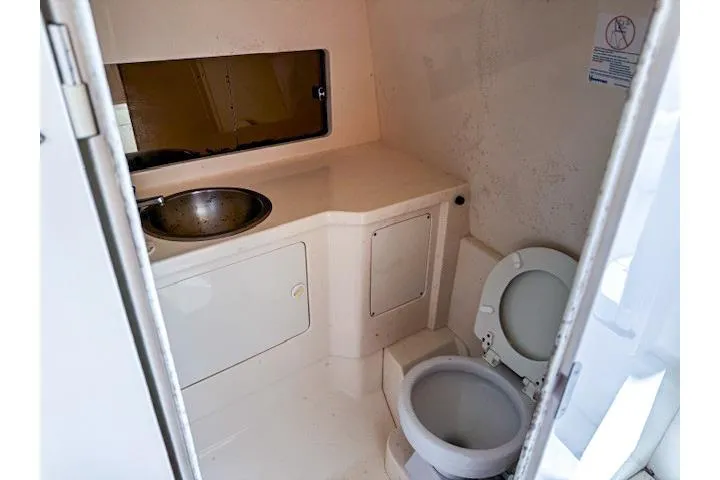  Yacht Photos Pics Compact bathroom in a 1999 Intrepid 356 boat, featuring a sink and toilet.