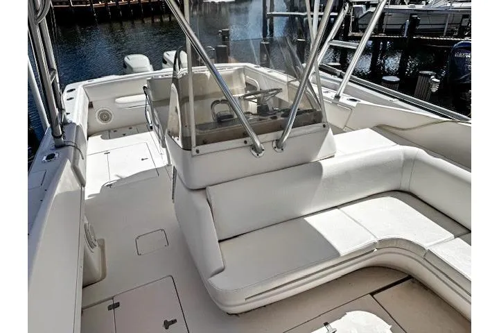  Yacht Photos Pics 1999 Intrepid 356 boat with white seating and helm, docked by the water.